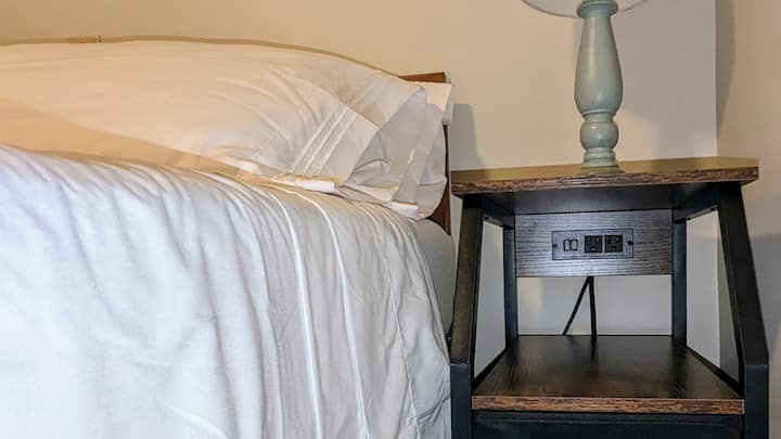 The nightstand has USB and 120 volt plugs for your phones and devices.