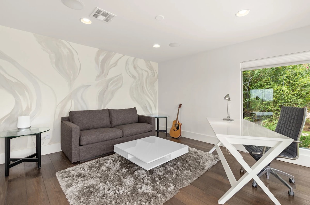 This multifunctional setup balances functionality and style. The office has a convertible queen sofa bed.