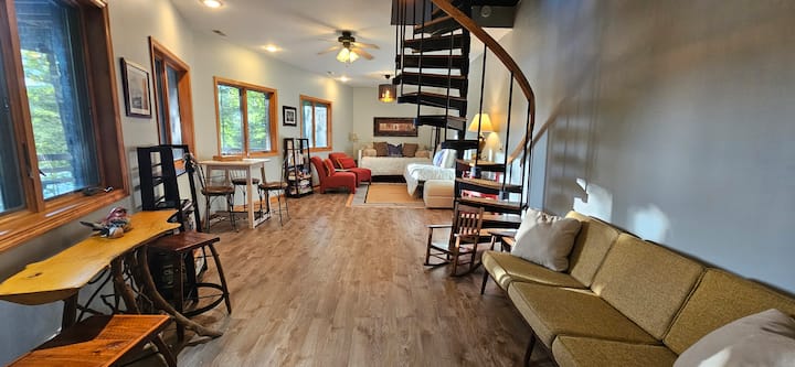 The lower level is stocked with books, puzzles, games, and cornhole. The ottoman stores linens for the trundle bed.