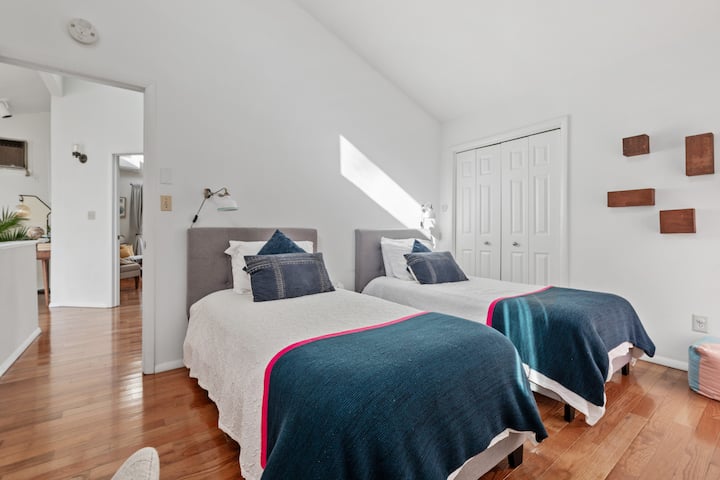 In the upstairs bedroom, you'll find two twin beds with luxurious mattresses and high-end linens, ensuring a comfortable and restful stay during your staycation.