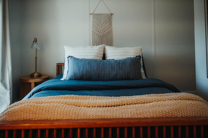 The third bedroom is a cozy blue themed room