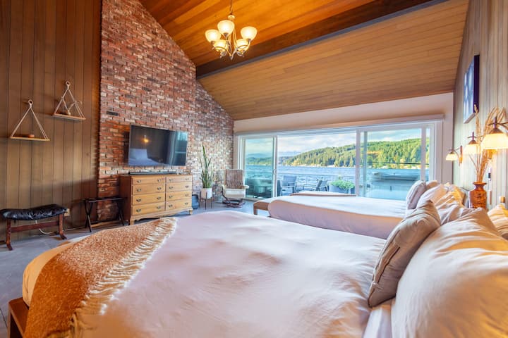 The charming master bedroom (1 of 3 bdrms) with 2 California King beds, TV/entertainment, comfortable and functional furniture, and the hot tub right outside. The master bathroom is attached. 