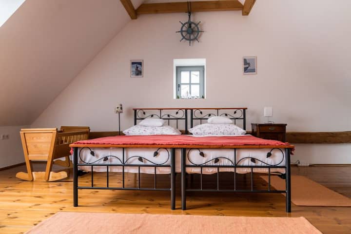 This room is usually used as a children's room for guests. It has a huge bed (180cm wide) that we can split into two single size beds. Games, cradle, foosball table, books.