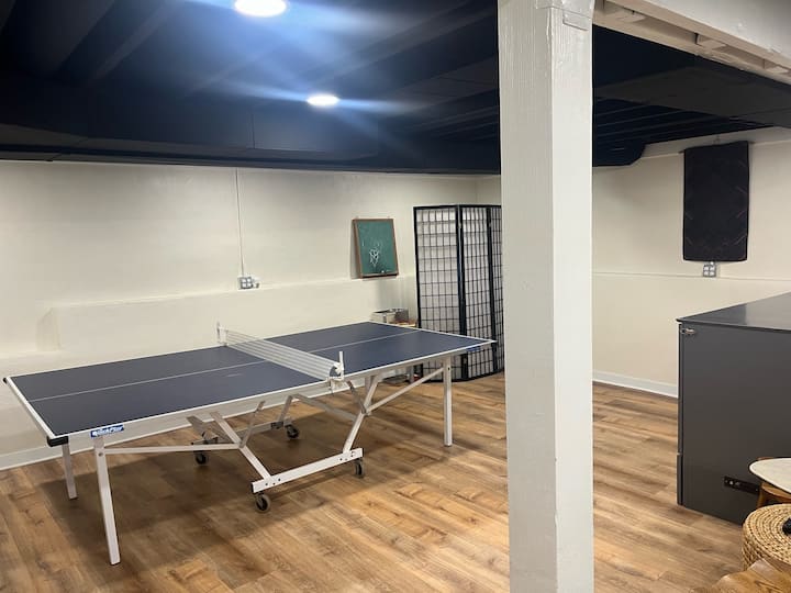 地下室宽敞，配有乒乓球、投影剧院屏幕、标准双人床和全功能卫生间。 