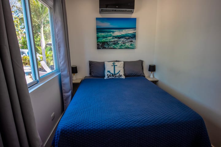 A comfortable queen sized bed in Casa Nautical