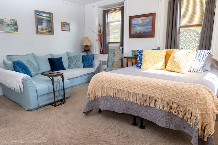 Cozy first-floor bedroom featuring a queen bed and a spacious pull-out sofa—perfect for relaxing with a movie or accommodating extra guests. Includes extra blankets and pillows for added comfort. Artwork that speaks to you.