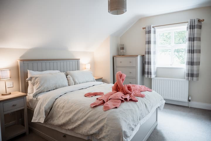 Bedroom two with double bed and 100% luxurious cotton sheets. Window looks west over one of our fields and the alpacas.