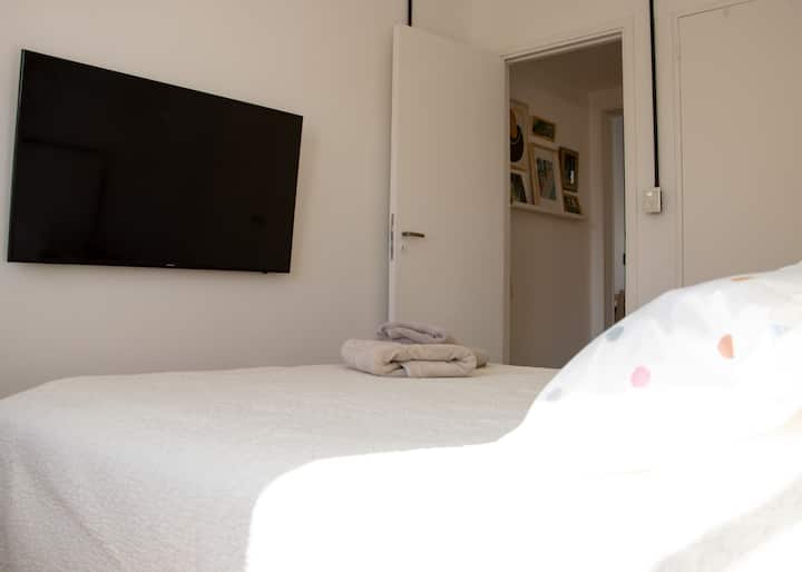 The room has Samsung smart TV.