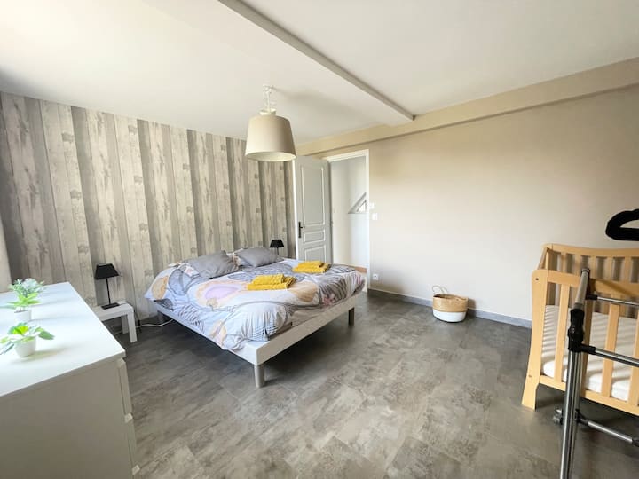 Habitación grande con cama doble, cuna y baño