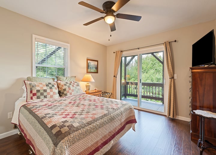 Bedroom with queen bed, ensuite bathroom and access to the lower deck.  
