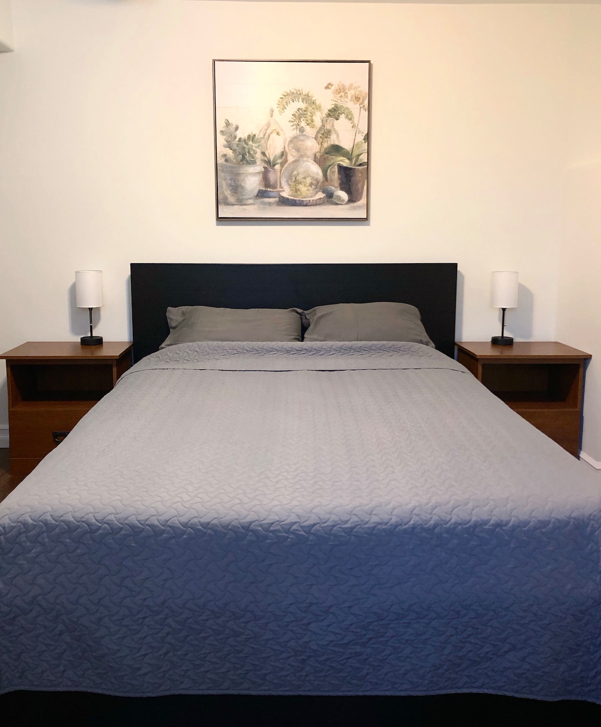 Queen bed. Bedside lamps have easily accessible outlets and USB charging ports.