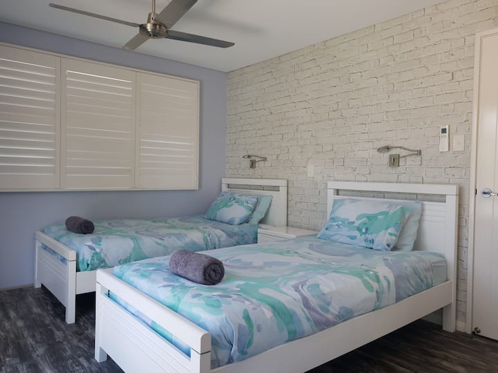 Bedroom 3 is located downstairs and has 2 king single beds 