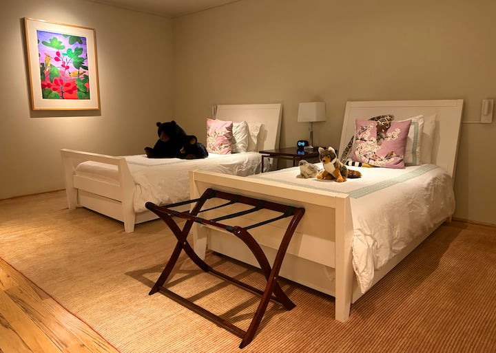 Second bedroom with two twin beds, two trundle beds, children's books and stuffed animals