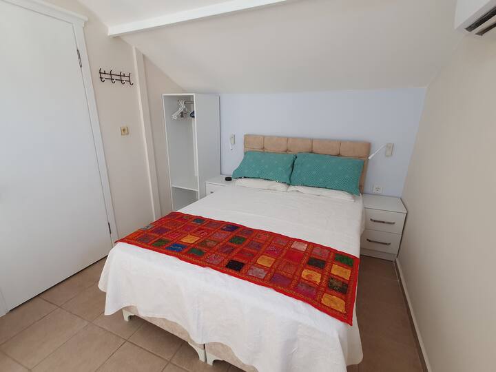Newly refurbished bedroom.  Now includes wardrobe and bedside table built-ins. Wall reading lights. Aircon.