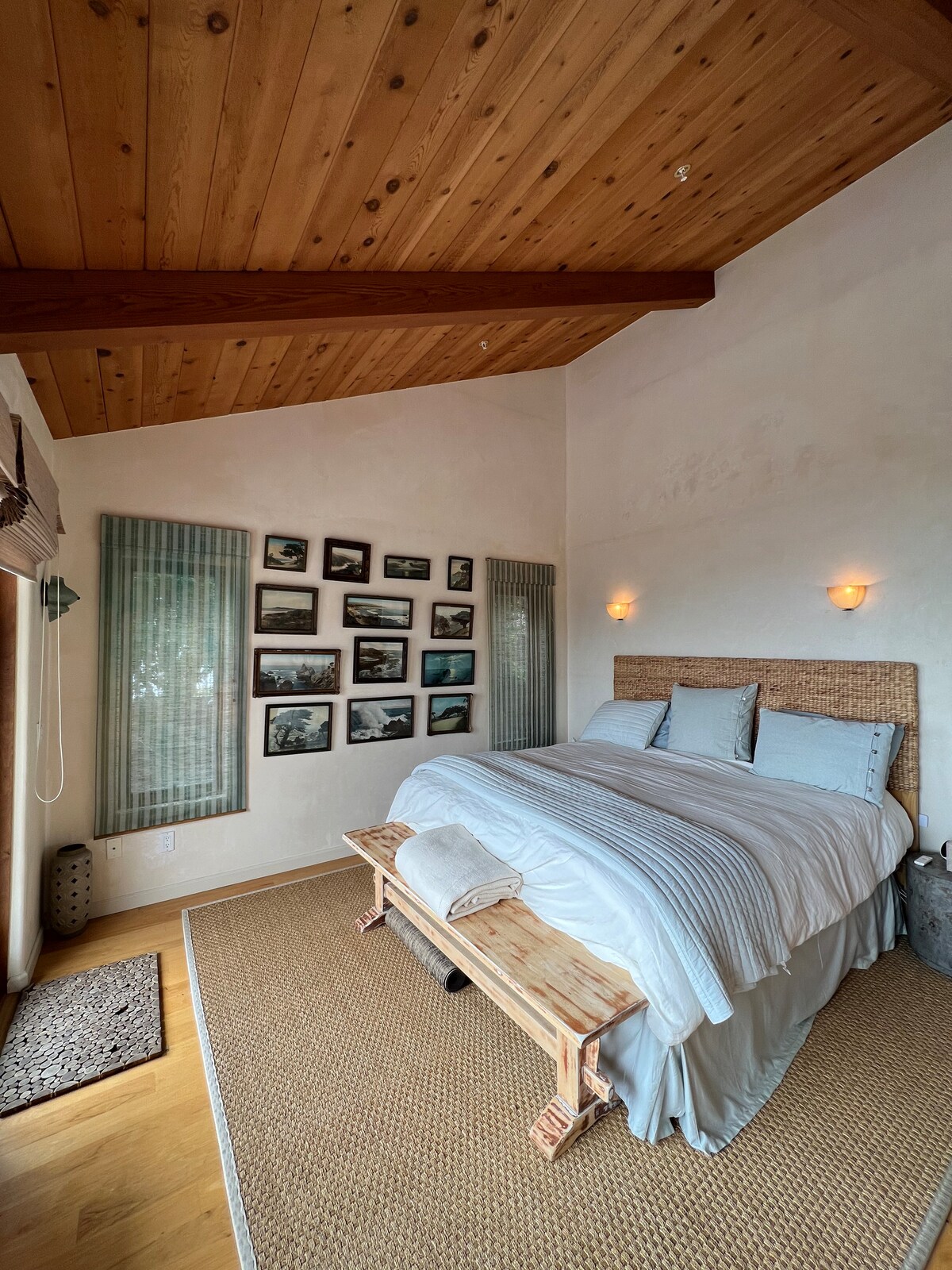 Enjoy the sound of the waves and a spectacular view from bed.  There’s a door to the deck, artisan nightstands, a seagrass rug, hand-dyed window shades,  artisan glass fixtures, and a dresser.  Bathroom en suite.