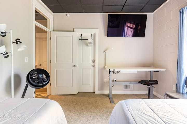 55’ LG OLED & large adjustable electric VariDesk. This allows you to work while sitting down or standing up :)