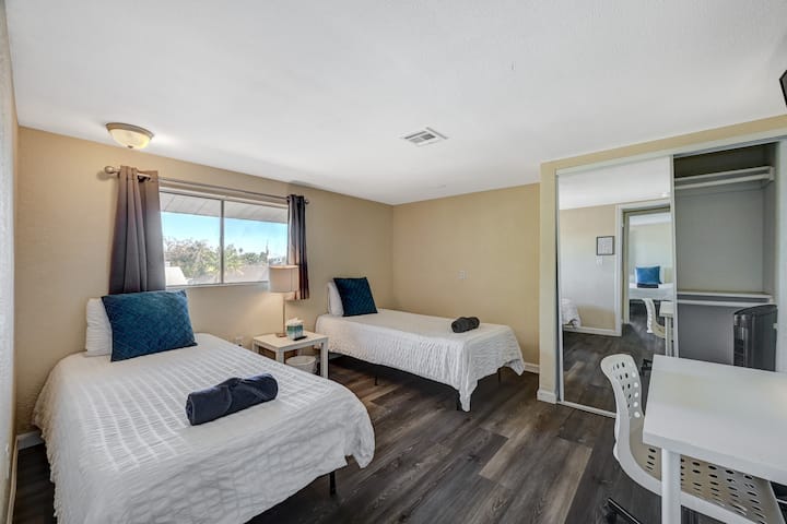 Up-close photos of the two single beds, featuring a beautiful Vegas skyline.
