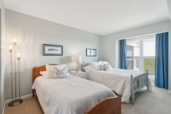 Bedroom #2 - Main Floor: Features a full-sized bed, twin bed, closet, dresser, Roku TV, and room darkening curtains. There is also private access to the hallway bath