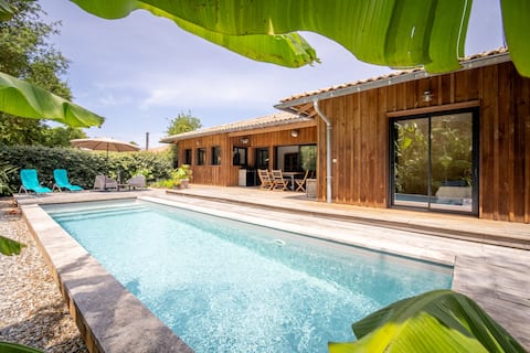 Wooden house with heated pool and view into forest