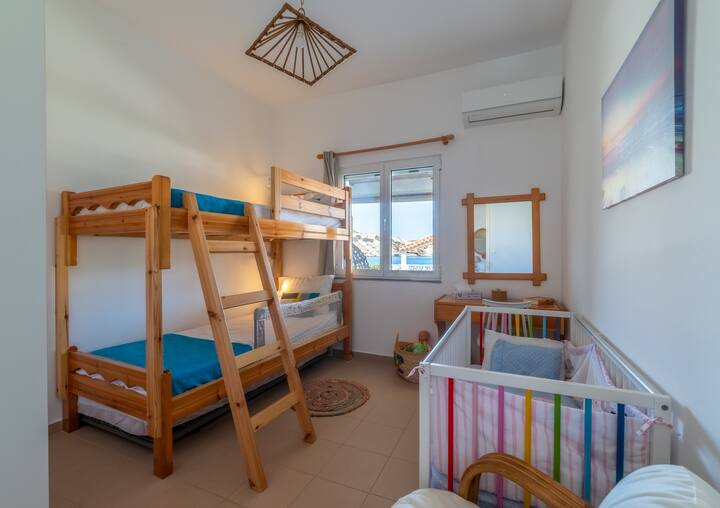 bedroom with bunk beds and a cot! it also has toys