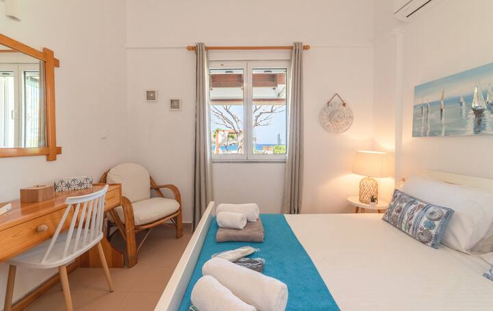 the blue room has a view of the garden and the sea