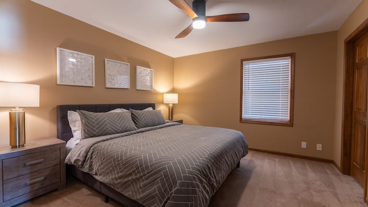 Primary bedroom with king size bed, en suite bathroom and walk-in closet off main hallway upstairs (across the hall from the queen bedroom).