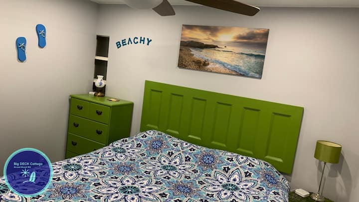 Largest front Beachy bedroom on the main level with a king size bed and double closet with luggage racks, with a night stands with charging ports for mobile devices. 