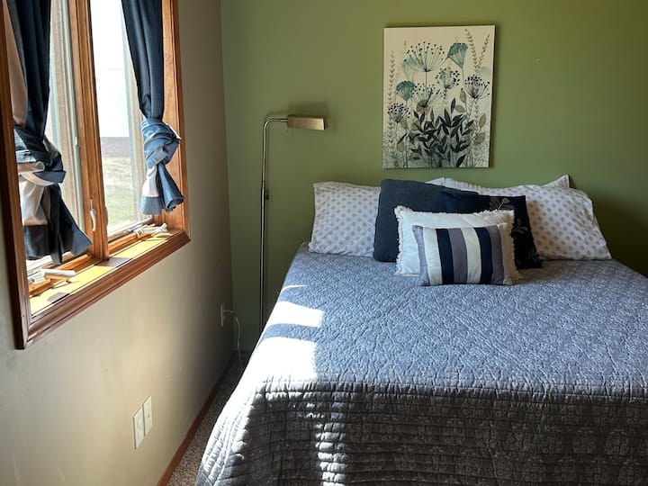 This upstairs bedroom has a comfortable queen bed with blackout curtains.  It shares a full bathroom with Bedrooom #3.