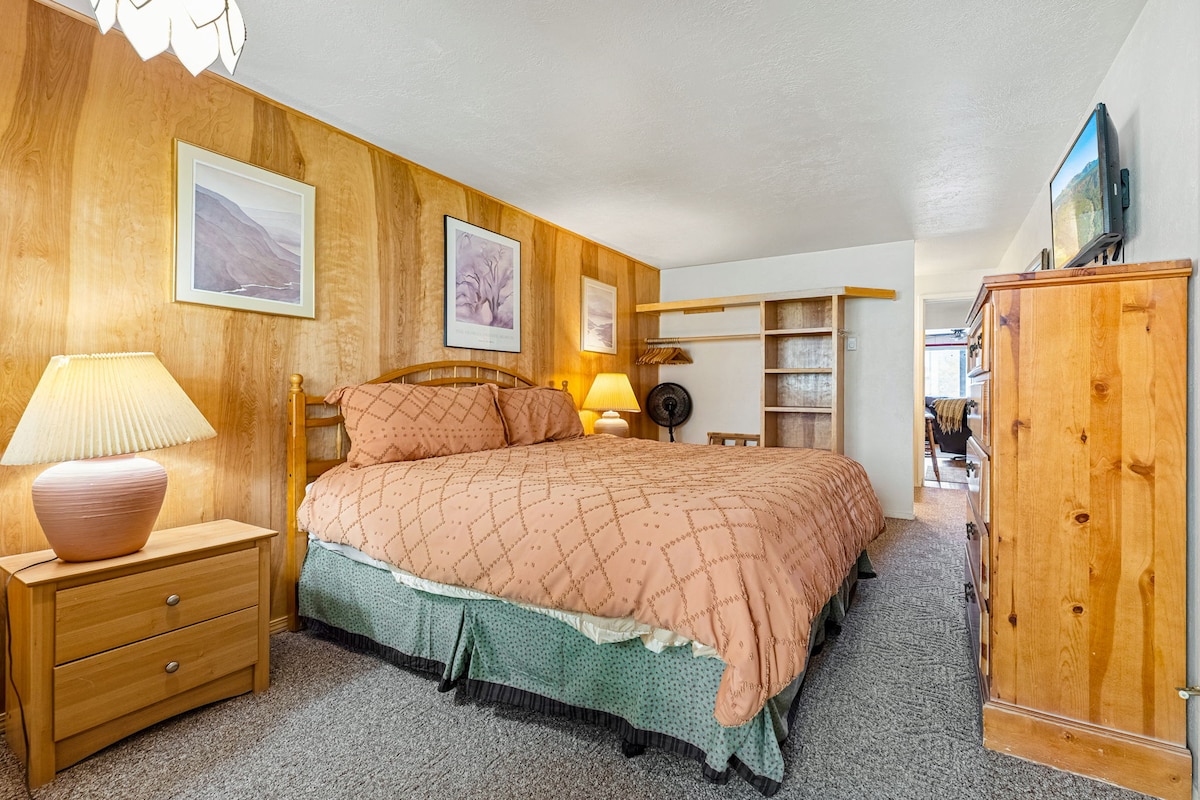 King bedroom with private bathroom.  Smart TV.  Exterior door access to hot tub, firepit, outdoor grill with picnic area, and ski slopes.