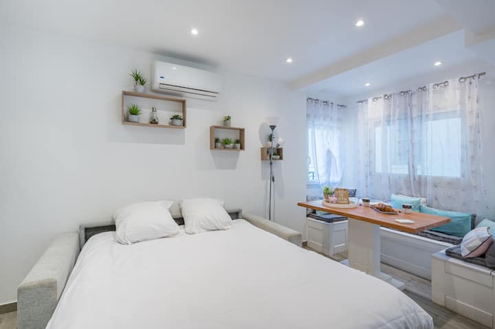 אזור שינה מעוצב היטב לנוחות אופטימלית בסטודיו מודרני.