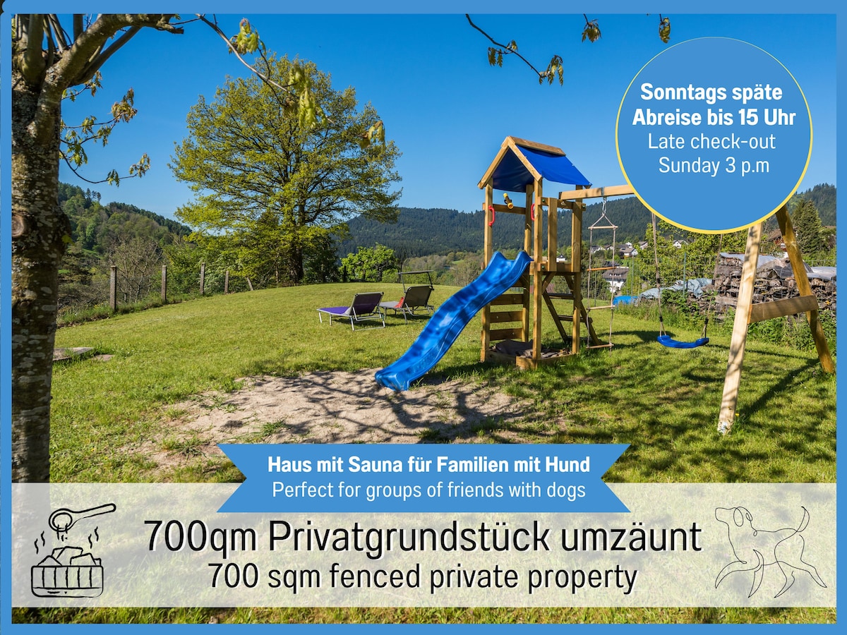 A large play area is showcased, featuring a playground with a slide and climbing frame set on a well-maintained lawn. The expansive, fenced garden measures 700 sqm, surrounded by lush greenery, providing a private space designed for families and their pets.