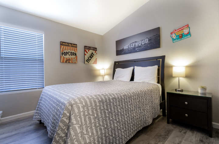 מיטת קווין סייז, שתי שידות לילה, מתלה מזוודות.