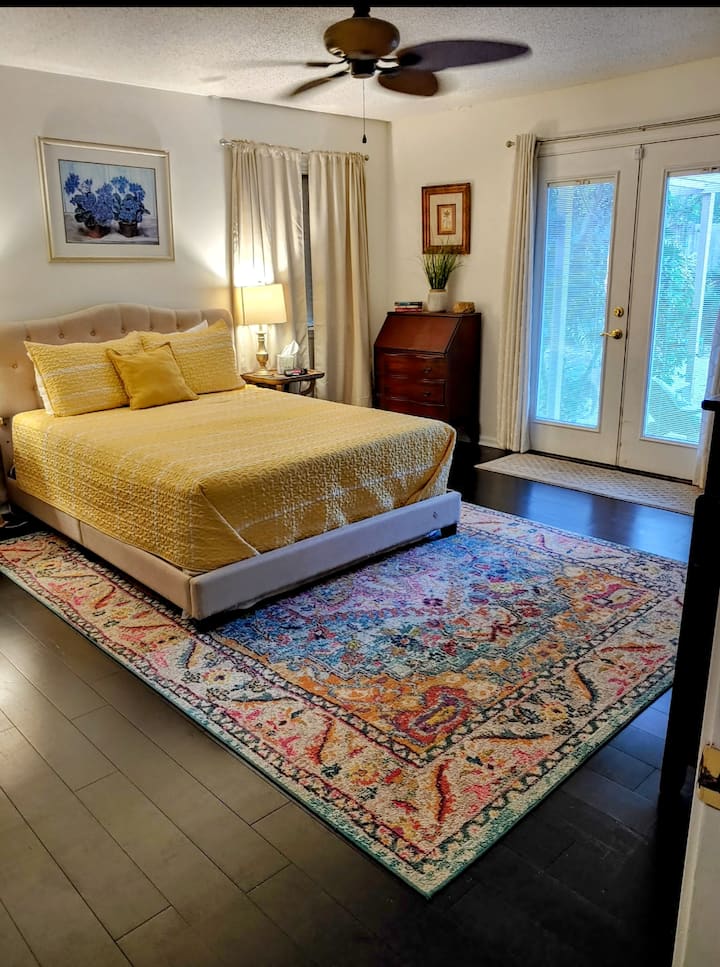 Голема главна спална соба со приватна бања и француски врати кои водат до просторот на терасата и базенот.