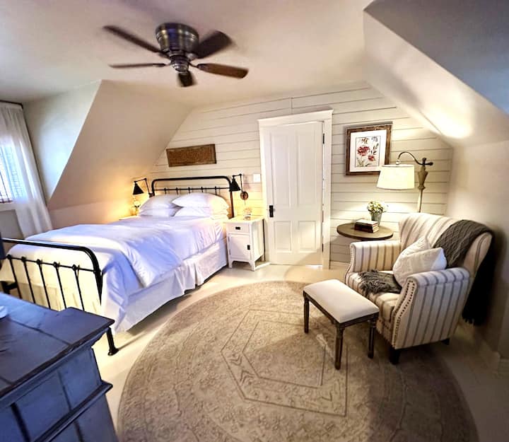 Spacious and unique upstairs main bedroom features a full ensuite bathroom all nestled under the unique attic roofline.