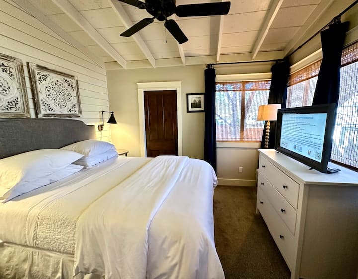 The downstairs back "fountain room" is a guest favorite and features soaring planked ceilings and overlooks the backyard and features a queen bed.  