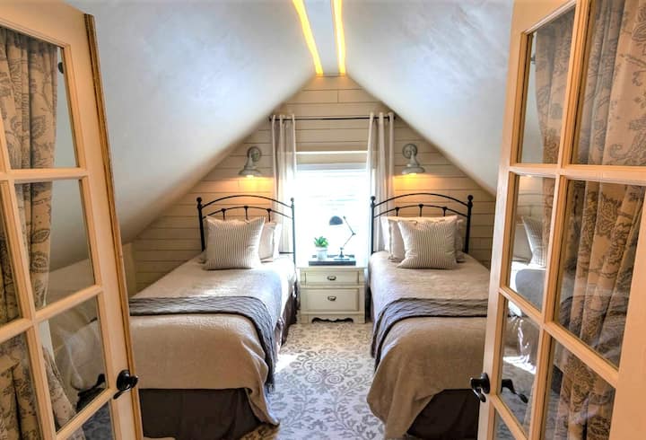 Welcome to the Gable Room!  Nestled under the attic front roofline, bedroom is wildly popular with both the kids and single adults alike.  Unique ambient lighting and shiplap accents lend a great deal of character to this unique and cozy room.
