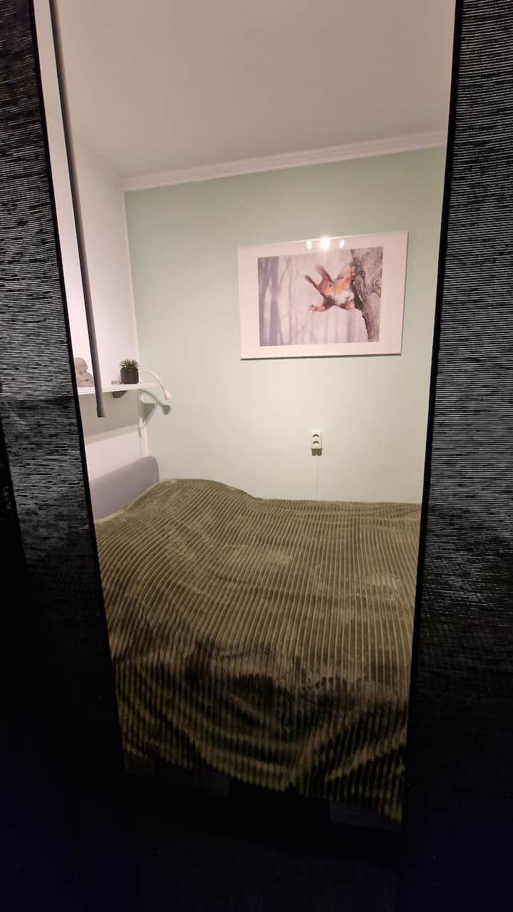 غرفة نوم أمامية بسرير 140 × 200 سم ولحافين منفصلين. على طول السرير، توفر ستائر اللوحة الخصوصية. للوصول إلى غرفة النوم الرئيسية، يجب أن تمر بغرفة النوم هذه.