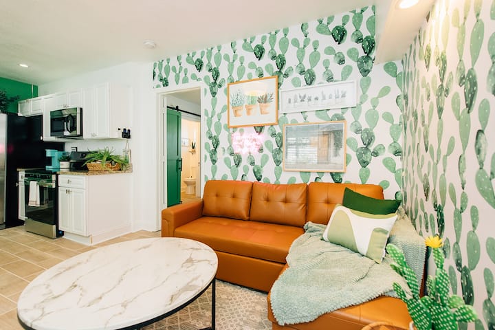  Comfortable seating, tropical wallpaper, and smart TV await.
