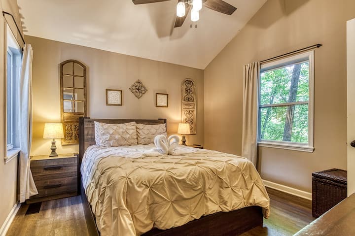 The main floor bedroom has a queen bed and a twin over twin bunk. It's attached to the main floor bathroom.