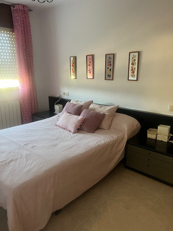 Habitación con una cama doble con ventilador y radiador
