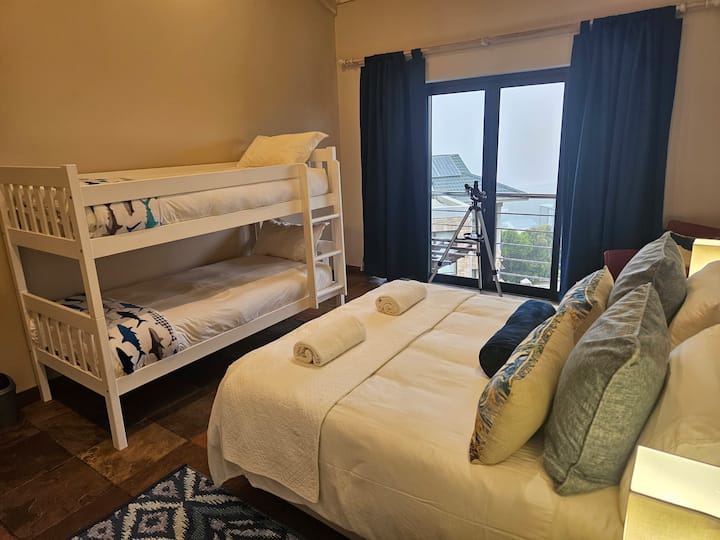 Chumba cha kulala cha wageni kilicho na kitanda cha ukubwa wa kifalme na vitanda vya ghorofa moja