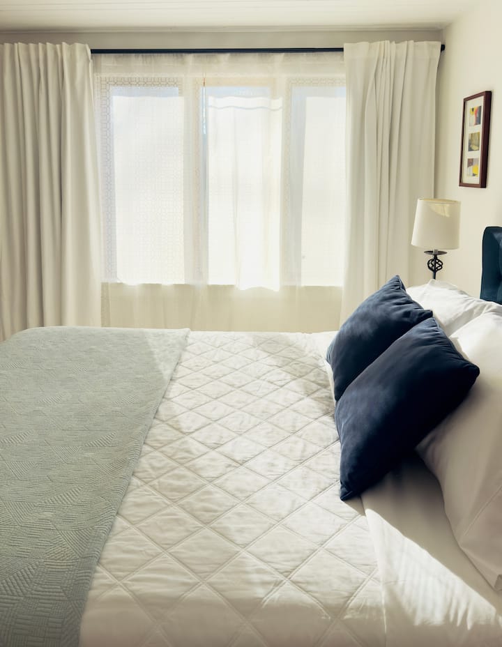 The south west bedroom has a queen bed, twin bed, closet, and bureau.