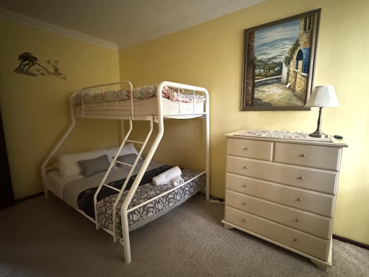Double bed with single bunk bed. Wardrobe and chest of drawers. 