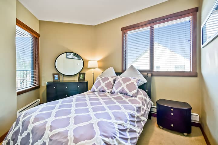 Full-sized bed in second bedroom, with closet and drawers