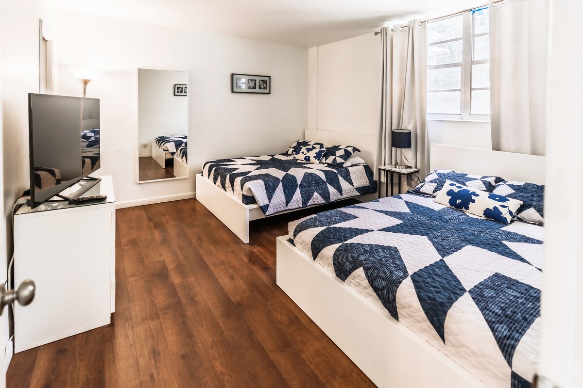 Priestranná spálňa s dvoma manželskými posteľami, inteligentnou televíziou, prirodzeným svetlom a šatňou pre ďalší úložný priestor – ideálne pre pohodlný skupinový pobyt.