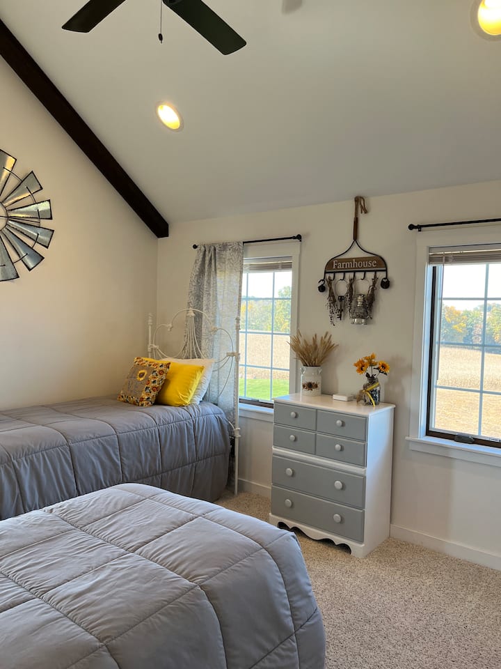 Sadies room has two twin beds and is decorated with a country flair.  