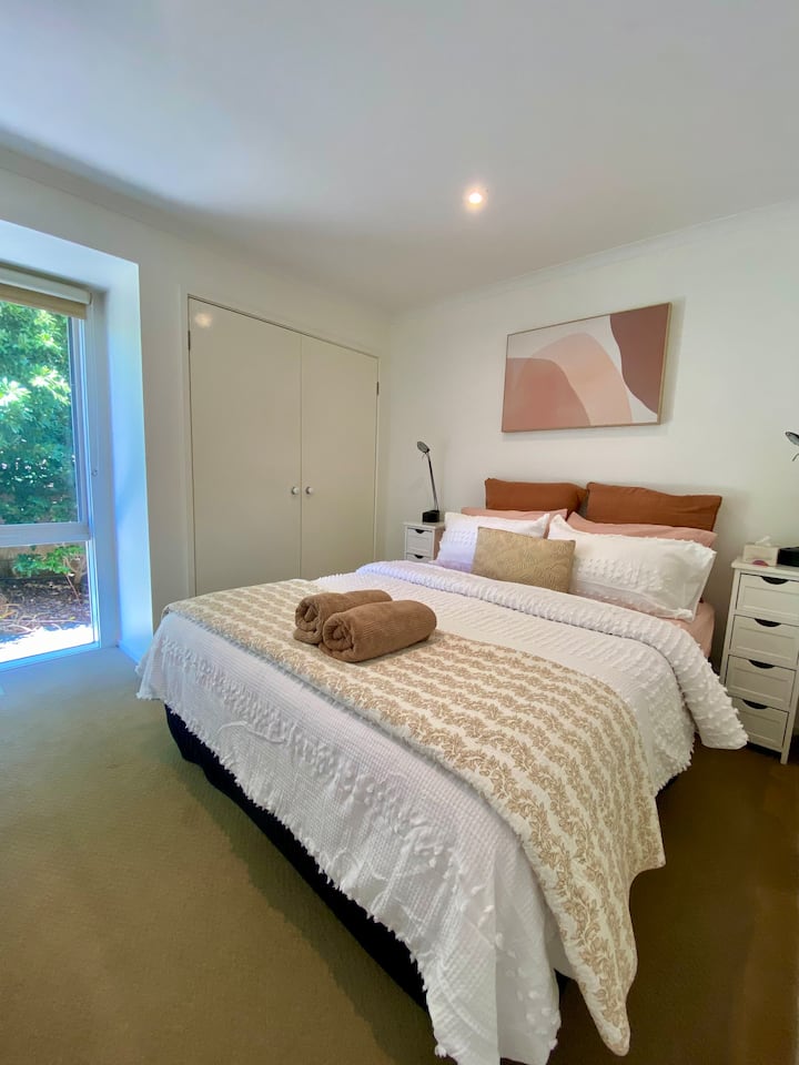 Bedroom 3 has a queen sized bed with robes and garden view.