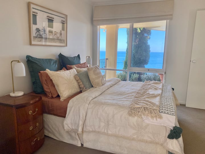 The master bedroom has its own ensuite (see bathroom 2 image), robes, and Bay views.