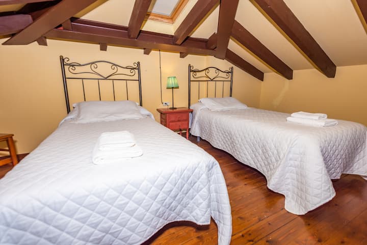 2 90cm beds in altillo abuhardillado, climb by steep stairs that we recommend climbing over 6 years old . No bathroom upstairs, just the two beds. You can use the bathroom of the room of the 2 beds that has two doors