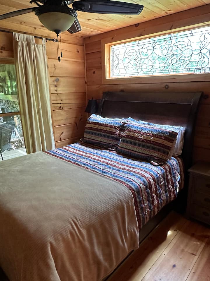 Bedroom one features a queen-size bed with crisp linens and seasonally-appropriate blankets